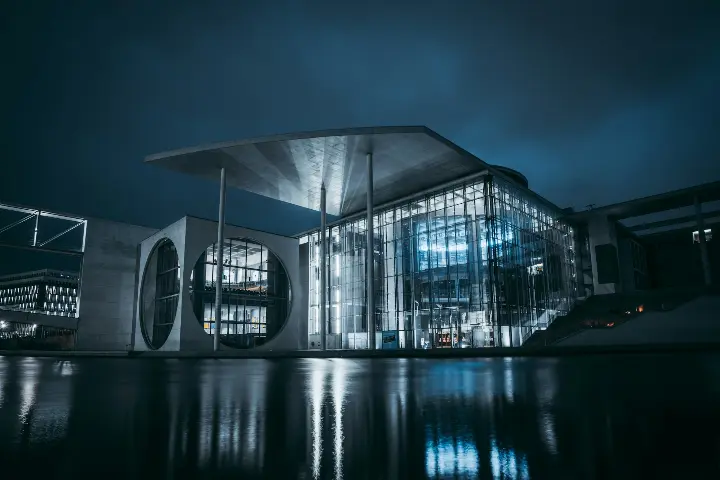 white and gray building near body of water during night time